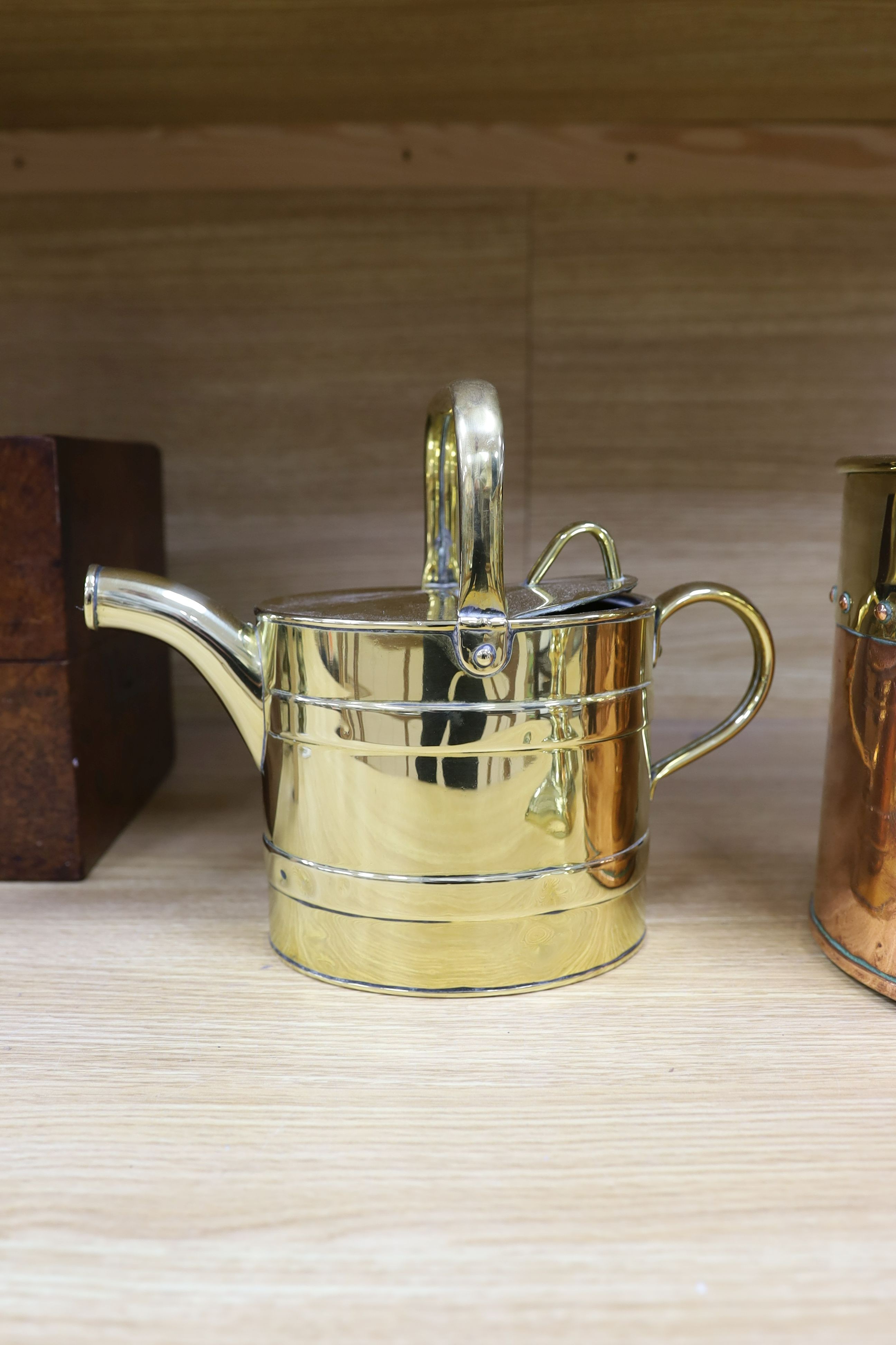 A Victorian copper jelly mould, pair of Victorian brass candlesticks 23cm, a brass water kettle, and a brass copper jardinière